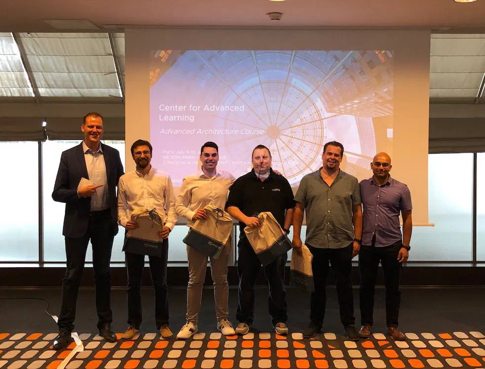 Team 5 group photo after winning 1st place in the Advanced Architecture Course final presentation
