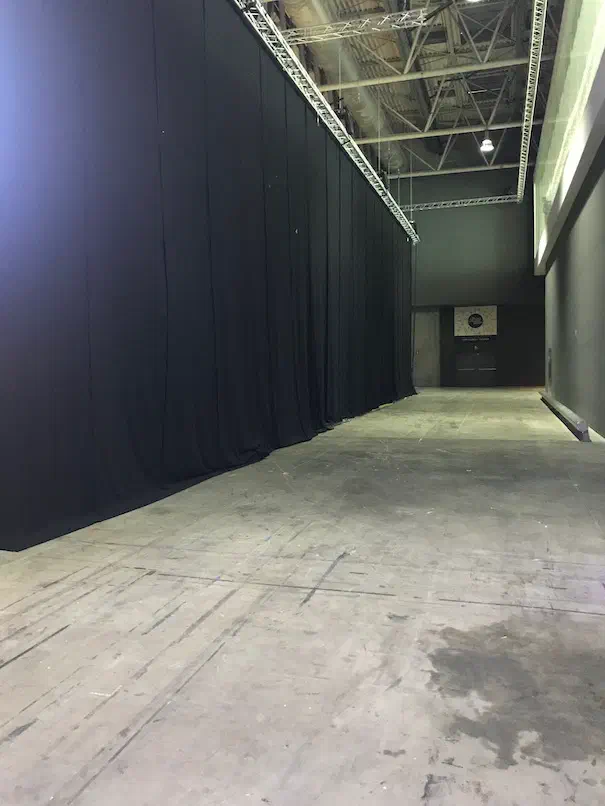 Empty hallway with a black backdrop curtain set up for headshots
